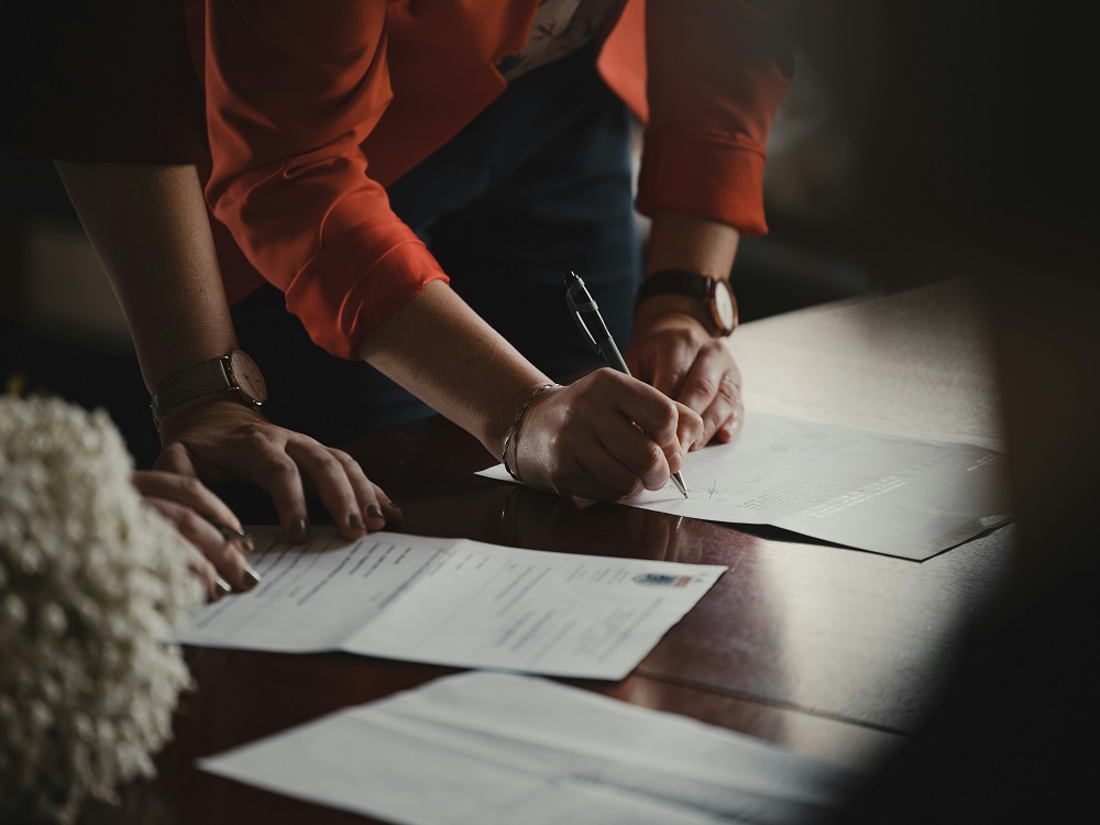 Photo of people reviewing and signing papers